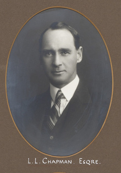 Black and white photograph of an oval portrait of a man in a suit with dark hair