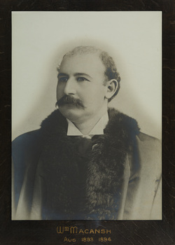 Black and white photograph of a formal portrait of a male from chest up against wearing mayoral robes.