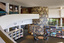 Photograph of a library in a round room, in the distance is a ceramic mural