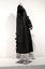 Photograph of a full length black robe with centre opening on a silver mannequin taken from the side. Has black velvet edging and is adorned with tassels.