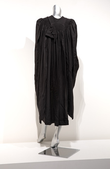 Photograph of a black ceremonial robe on a silver mannequin.