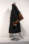 Photograph taken from a side view of a black ceremonial mayoral robe with brown fur trim on a silver mannequin.