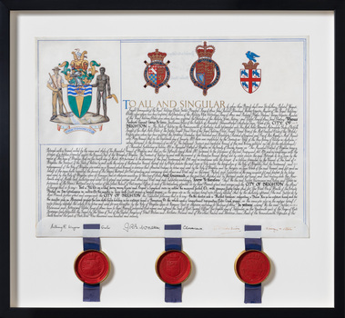 Parchment certificate of the City of Brighton Coat of Arms with three red wax seals connected at the bottom with blue ribbons in a black frame.