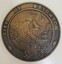 Round cast bronze plaque for City of Brighton crest, with a coastal scene in the centre and British Coat of Arms at the bottom.