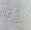 Embossed round seal for "CITY OF SANDRINGHAM" onto white paper containing coat of arms in centre
