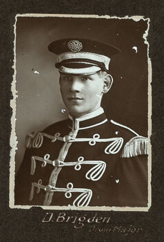 Black and white photograph of a man in uniform with his name written underneath on the mount