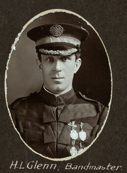 Black and white oval photograph of a man in uniform with his name written underneath on the mount