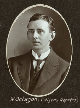 Black and white oval photograph of a man in a suit with his name written underneath on the mount
