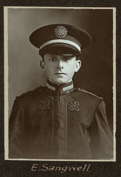 Black and white photograph of a man in a uniform and cap with his name written underneath on the mount