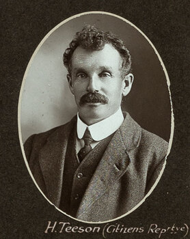 Black and white oval photograph of a man in a suit with his name written underneath on the mount
