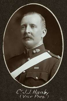 Black and white oval photograph of a man in a uniform with his name written underneath on the mount