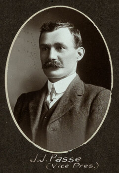 Black and white oval photograph of a man in a suit with his name written underneath on the mount