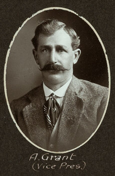 Black and white oval photograph of a man in a suit with his name written underneath on the mount
