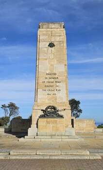 Large World War One memorial of a stone cenotaph with bronze decoration at its base, surrounded by a stone terrace.