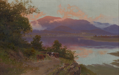 Landscape with brown cows walking down shrubby track next to lake with sail boats. In the background there are buildings with chimney smoke and large mountains with low cloud reflecting mauve and blue colours on the lake.