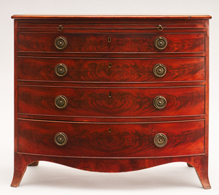 Mahogany bowed front chest of drawers with bronze handles, dusting slide and simple splade feet.