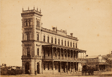 City Hotel in Sandhurst with two men standing in front of the building and a carriage on the street