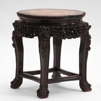 small round pedestal t able with a marble taple top