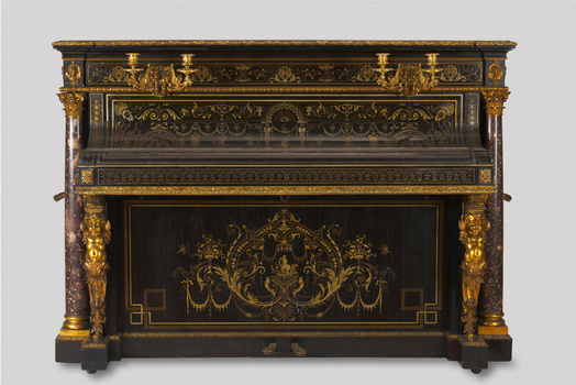 an upright piano with two candleholders attached to the upper front board. steel frame, ebony case inlaid with brass, ormolu and silver, ormolu mounts, scagliola columns
