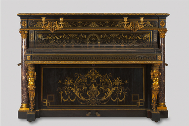 an upright piano with two candleholders attached to the upper front board. steel frame, ebony case inlaid with brass, ormolu and silver, ormolu mounts, scagliola columns