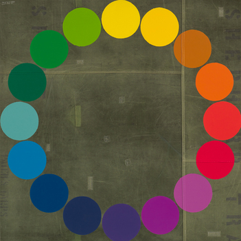 A circle made of coloured circles on a grey background.