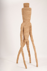A sculpture of a parsnip-style form with four legs entirely made of plywood.