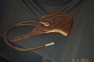 A leather flying helmet with communication cables