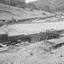 Wooden sluice flowing into dam.