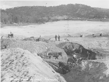 Men working in horses and carts, clearing land to alter the path of a river.