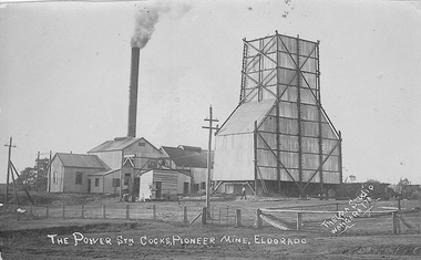 Buildings with smoke coming out of chimney stack.