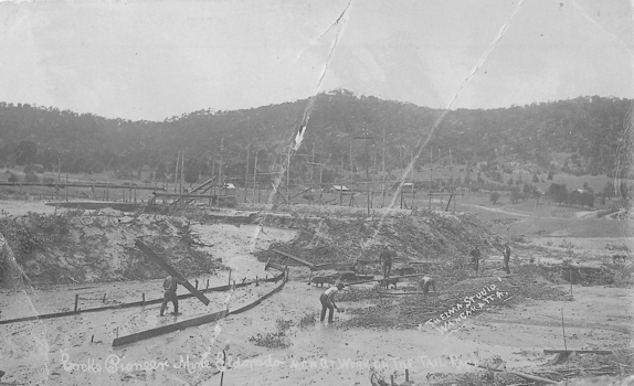 Men working on the construction of a channel to carry water away.