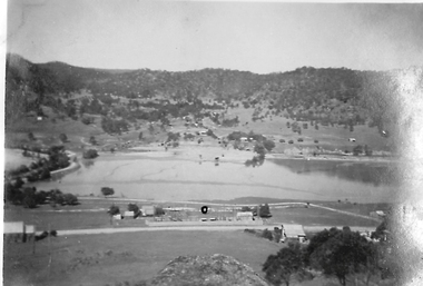 Large pond in front of hills.