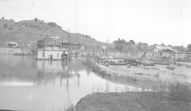 Barge with with processing shed in pond.