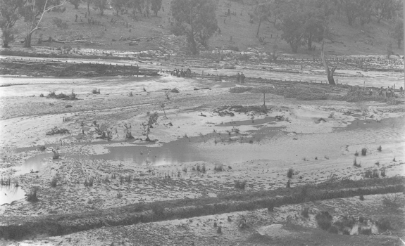 Near empty dam with pools of water.
