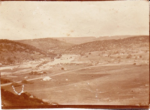 White farm house with sluicing pond used for mining behind i.