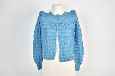 front view of blue knitted children's cardigan with three buttons