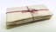 a stack of paper documents tied with pink cotton