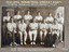 Group portrait of 11 white men in cricket uniforms