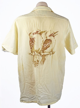 back view of a cream coloured shirt with a pair of brown kookaburras printed on the back