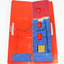 view from above of folded blue paper lantern attached with a ring binder spine to red card