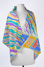 front view of a vibrant coloured scarf draped over a mannequin, colours include turquoise, purple, yellow, blue and orange.