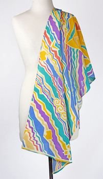 front view of a vibrant coloured scarf draped over a mannequin, colours include turquoise, purple, yellow, blue and orange.