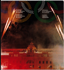 graphic showing a building lit with red lights and fireworks above, graphic of olympic rings at top of page with white text inside rings