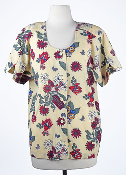 front view of a cream short sleeved shirt with native botanical print