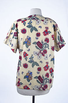 back view of a cream short sleeved shirt with native botanical print