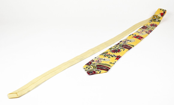 tie showing cream back and yellow front with native botanical design