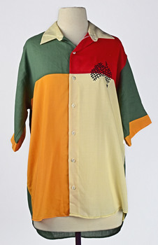 front of shirt showing block colours of green, yellow, cream and red with black map of Australia stitched in top right corner