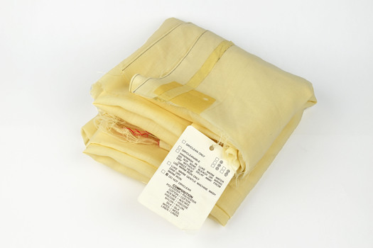 folded cream fabric with paper tag