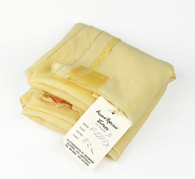 folded cream fabric with paper tag