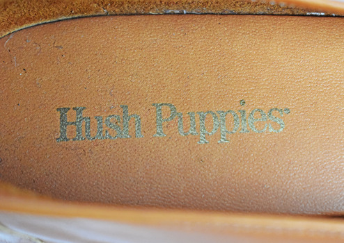 printed silver inscription on inner sole of shoe which says hush puppies